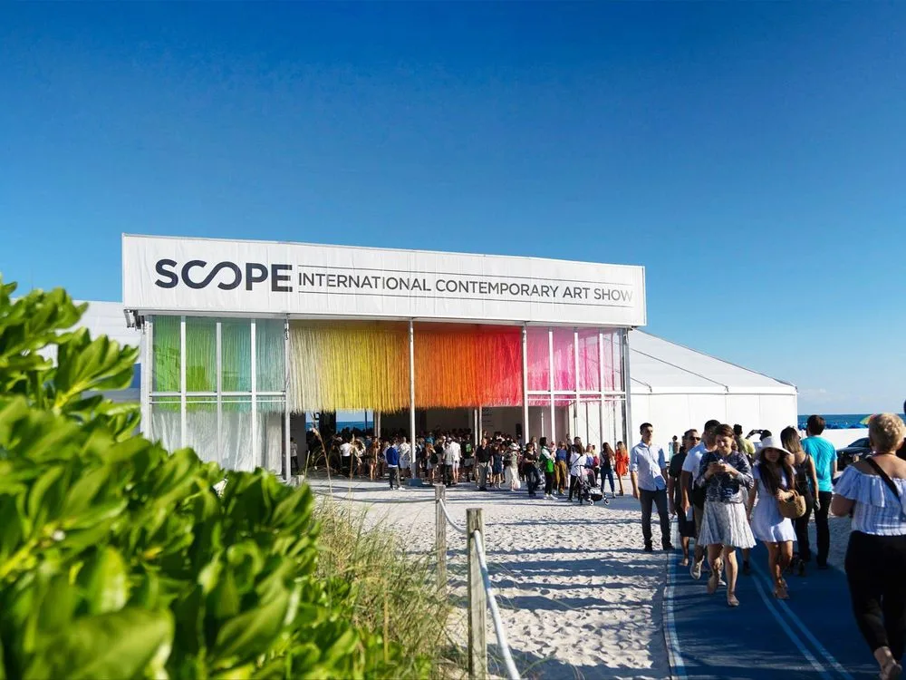 Visitors on the boardwalk outside a SCOPE Art Show pavilion