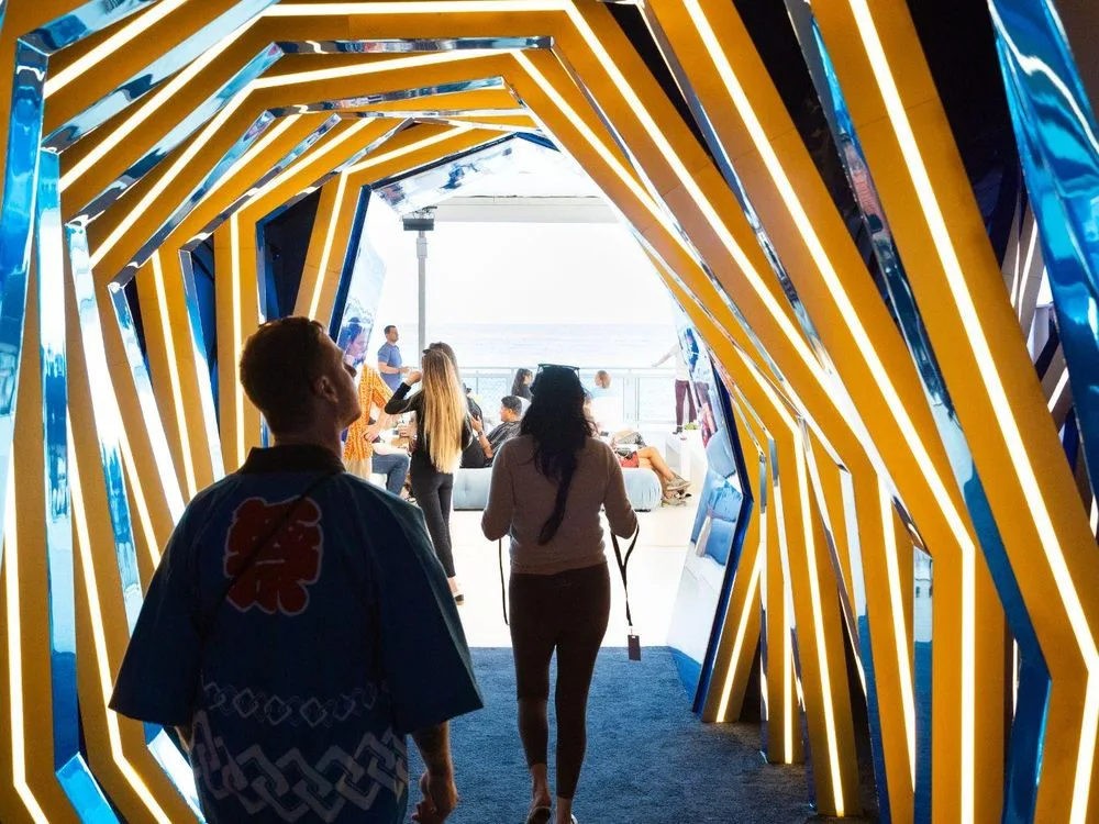 An installation of glowing frames leading visitors through a gallery