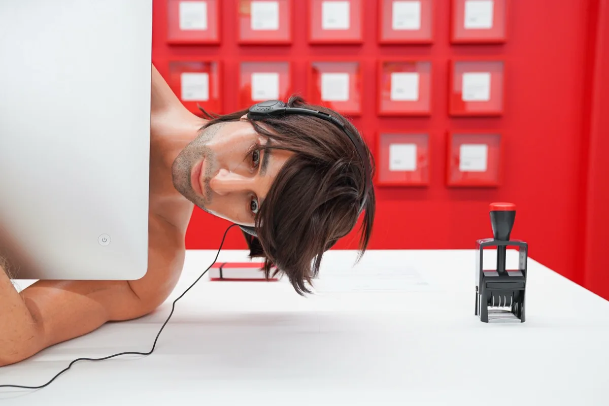 A lifelike sculpture of a man in headphones